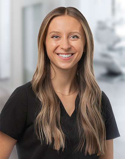 Dental hygienist smiling in a clinical setting