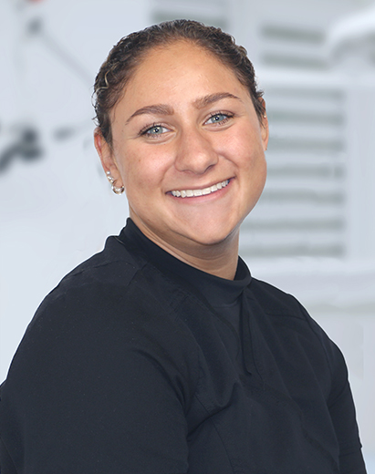Peyton, a dental assistant, smiling in a clinical dental setting