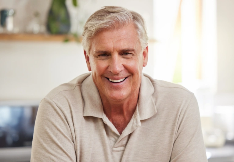 Confident man with a natural-looking smile after receiving dental implants at Cottonwood Dental in Salt Lake City