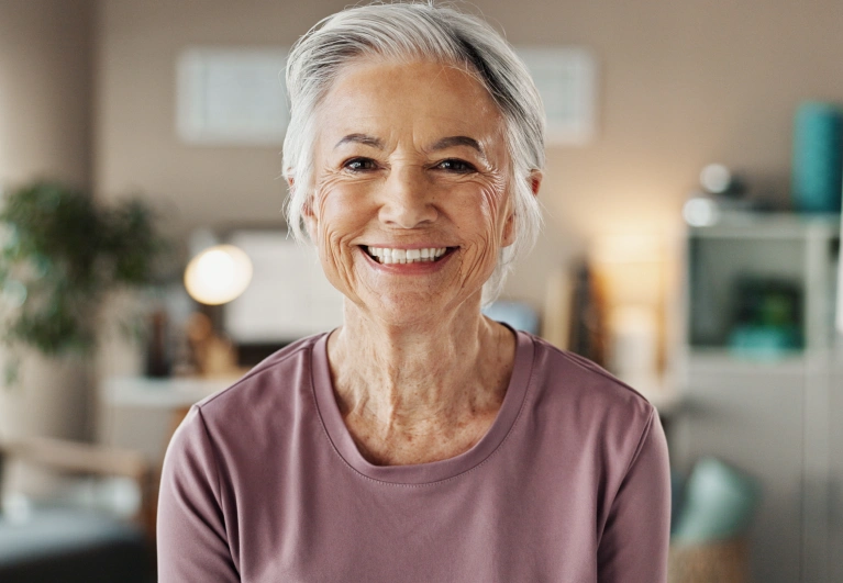 Happy patient smiling confidently with new dentures from Cottonwood Dental.