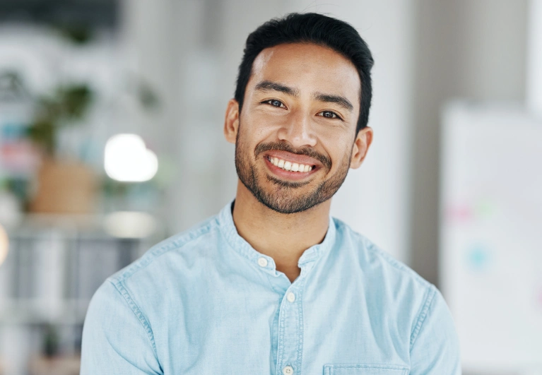 Man with bright, flawless smile showing results of porcelain veneers from Cottonwood Dental, trusted cosmetic dentist in Salt Lake City